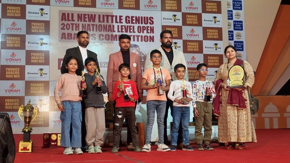 Students on stage with trophies at 20th National Level Open Abacus Competition