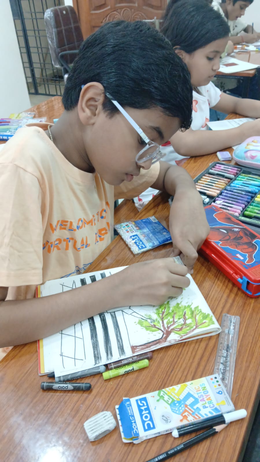 Student drawing with pencil at Art Therapy Workshop Manish Nagar Nagpur